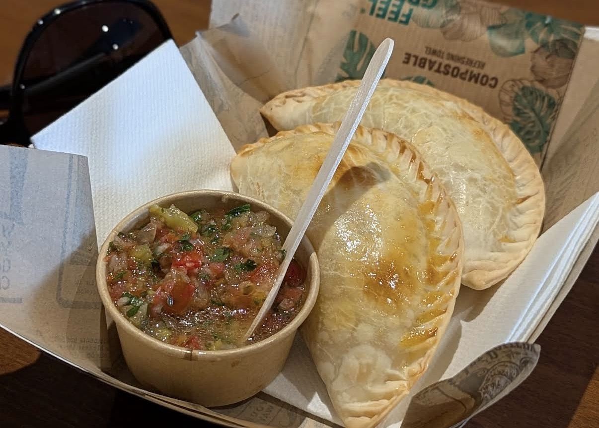 Hand-folded empanadas with salsa criolla