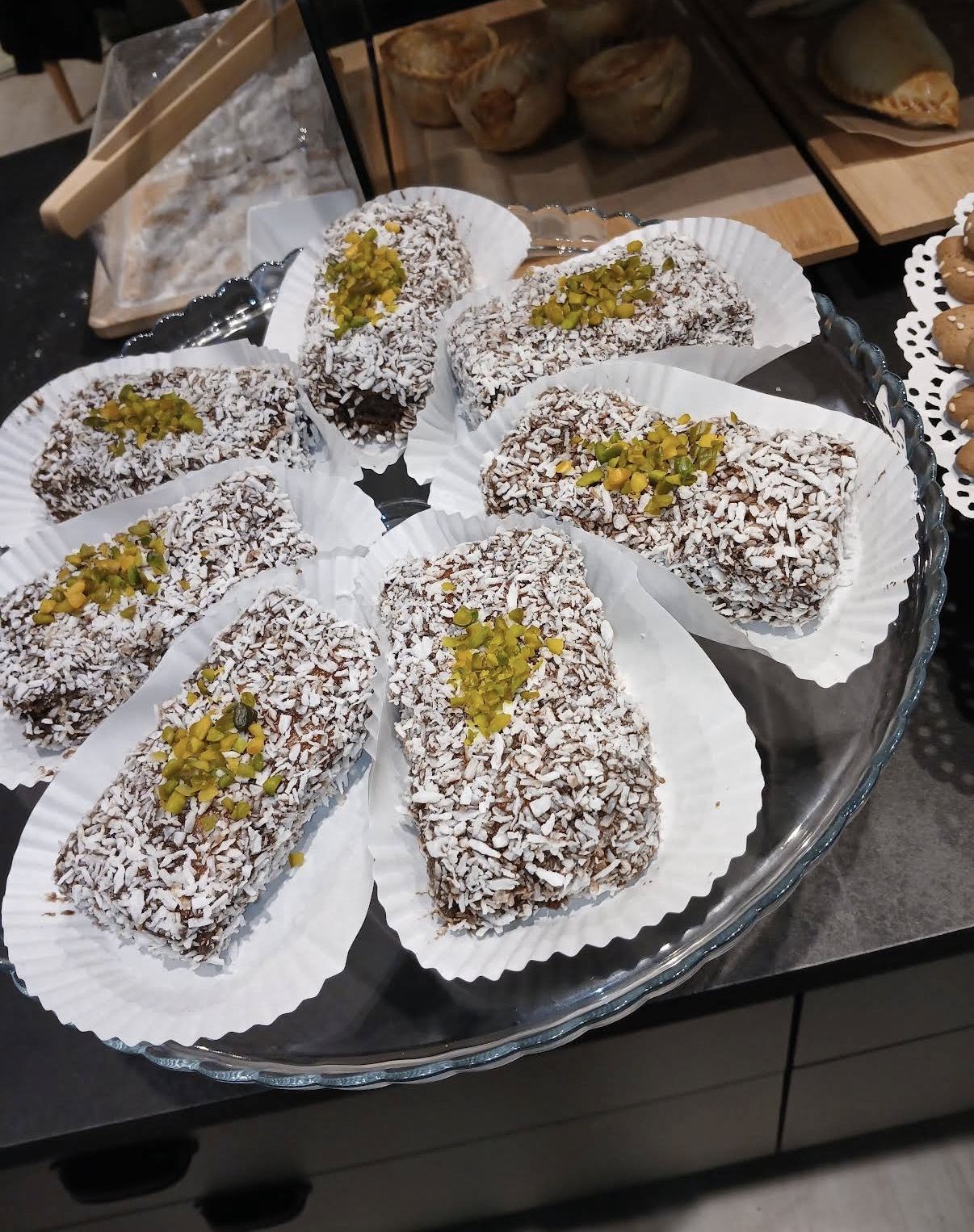 Lamingtons rolled in coconut with pistachio