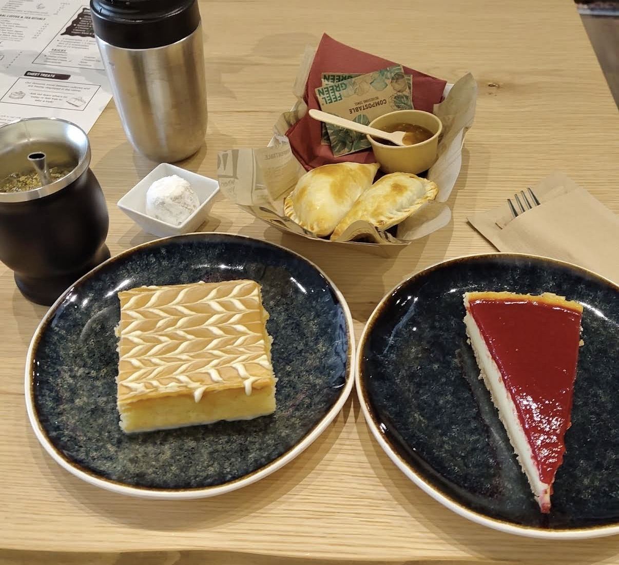 Maté in the traditional gourd with metal straw, empanadas and sweets