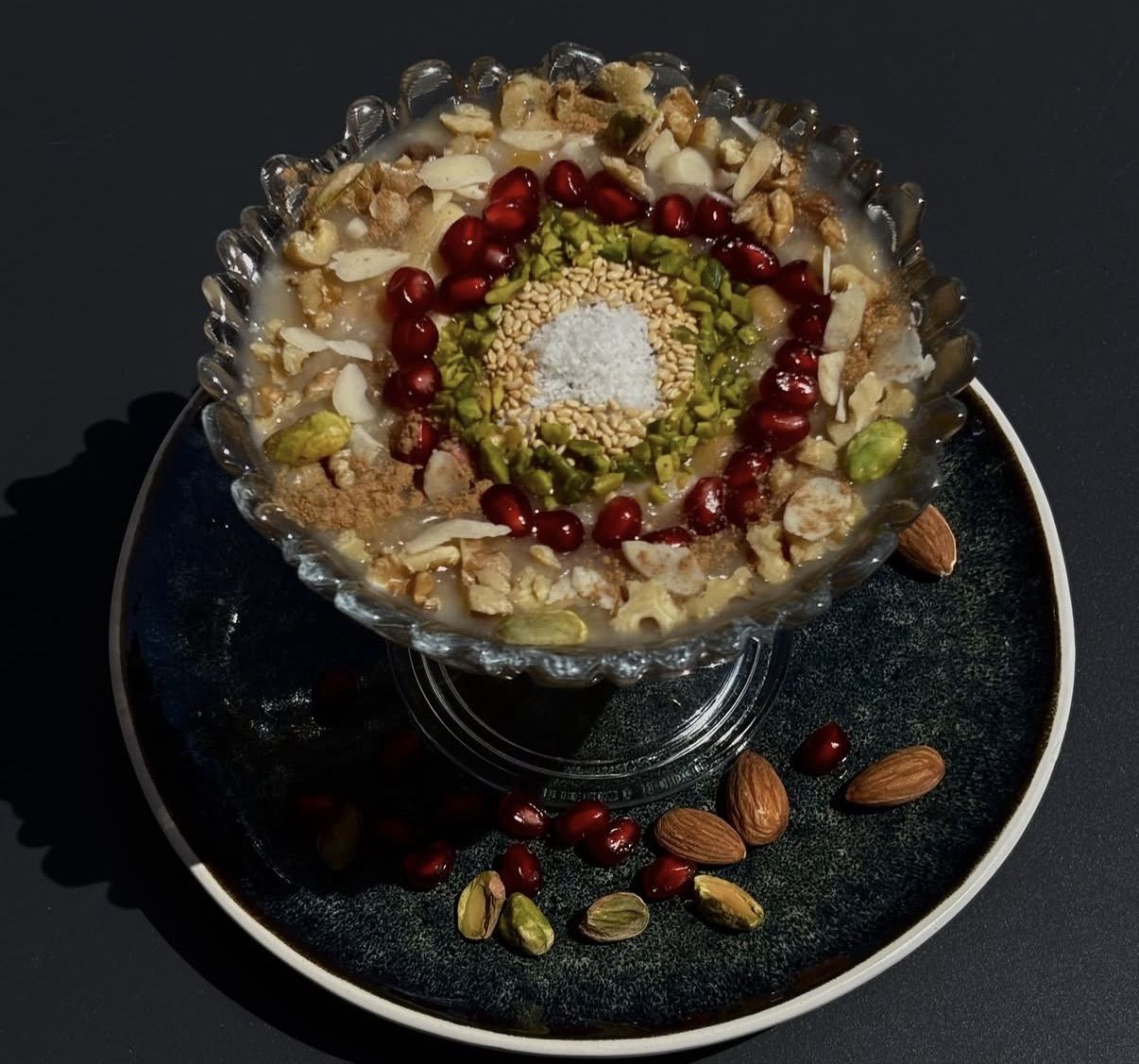 Milk pudding with pomegranate, pistachio, sesame and coconut