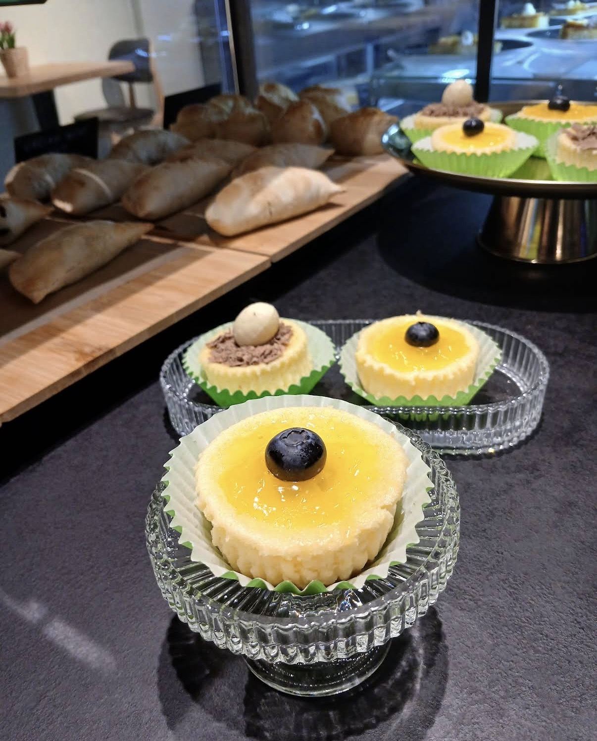 Mini cheesecakes with lemon glaze and blueberry on glass stands
