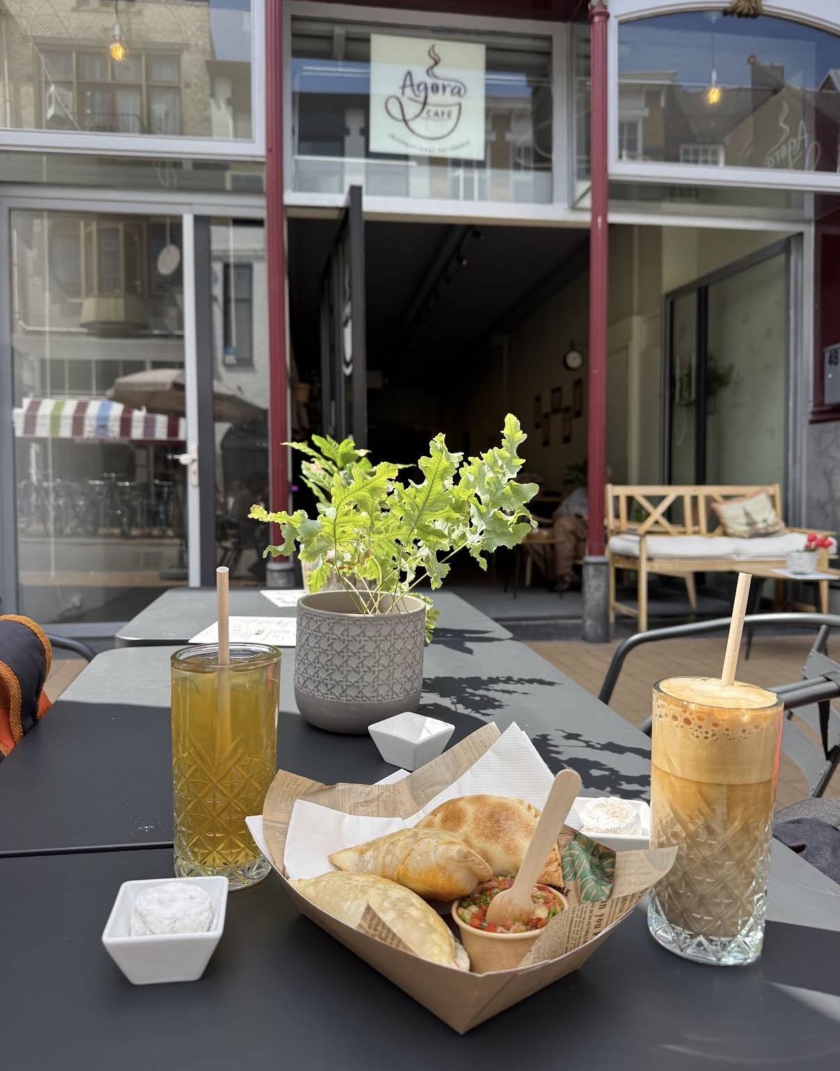 Freddo and iced tea on the terrace, café entrance behind
